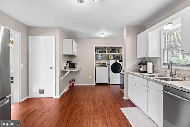 kitchen featuring white cabinetry, sink, stainless steel appliances, dark hardwood / wood-style flooring, and independent washer and dryer