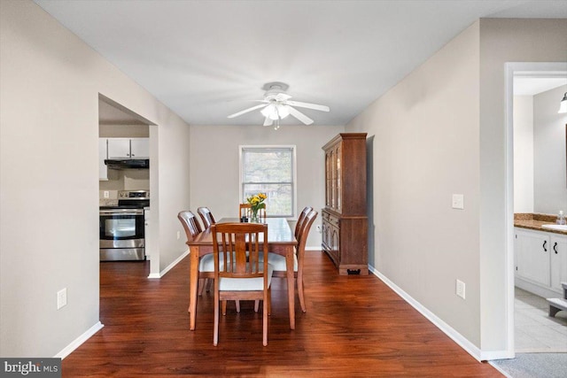 dining area featuring ceiling fan and dark hardwood / wood-style flooring