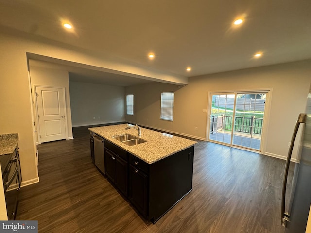 kitchen with light stone counters, sink, a center island with sink, dishwasher, and dark hardwood / wood-style floors