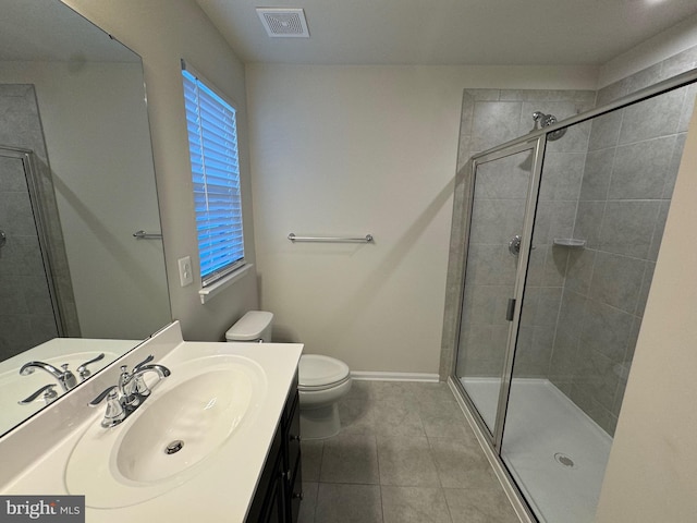 bathroom featuring tile patterned floors, vanity, toilet, and walk in shower