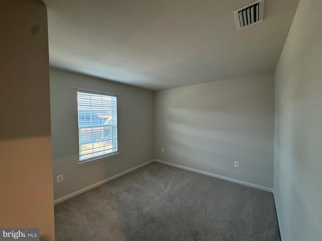 empty room featuring dark colored carpet