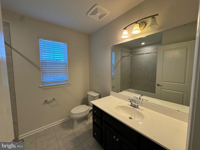 full bathroom featuring tile patterned flooring, vanity, tiled shower / bath combo, and toilet