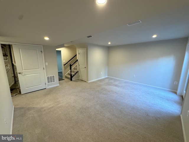 basement featuring light colored carpet