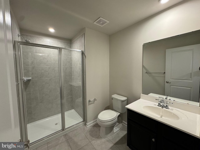 bathroom featuring toilet, vanity, tile patterned floors, and an enclosed shower