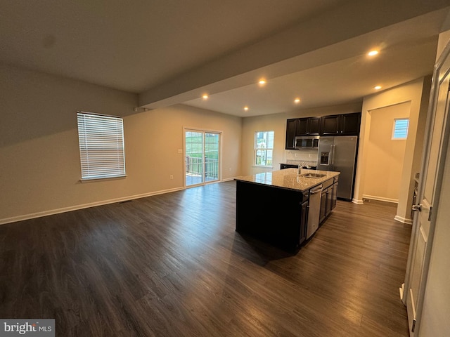 kitchen featuring sink, stainless steel appliances, dark hardwood / wood-style floors, and an island with sink