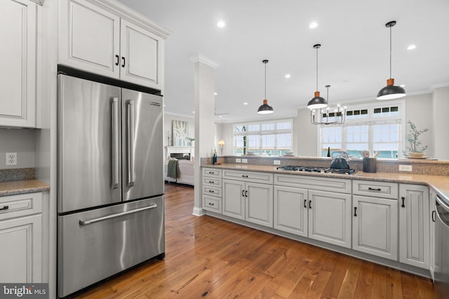 kitchen featuring white cabinetry, crown molding, stainless steel appliances, and light wood-type flooring