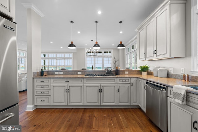 kitchen with white cabinets, stainless steel appliances, dark hardwood / wood-style floors, and ornamental molding