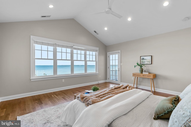 bedroom with hardwood / wood-style floors, a water view, vaulted ceiling, and ceiling fan