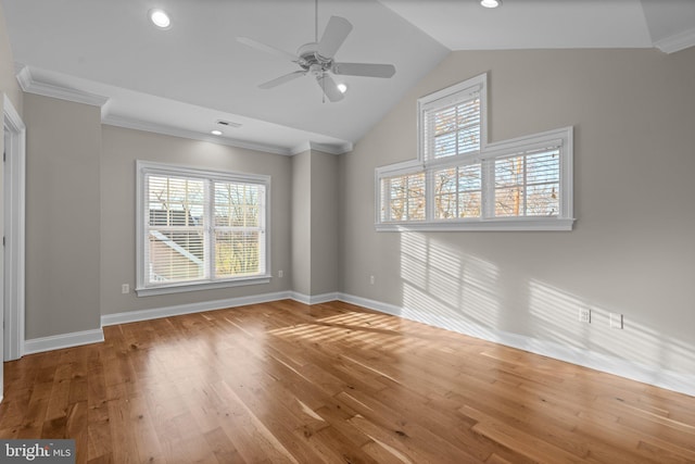 unfurnished room featuring hardwood / wood-style floors, ceiling fan, lofted ceiling, and crown molding