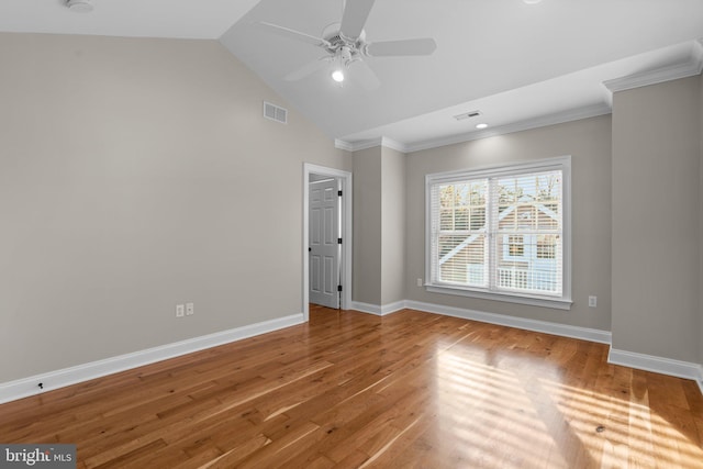 spare room with hardwood / wood-style floors, crown molding, ceiling fan, and lofted ceiling