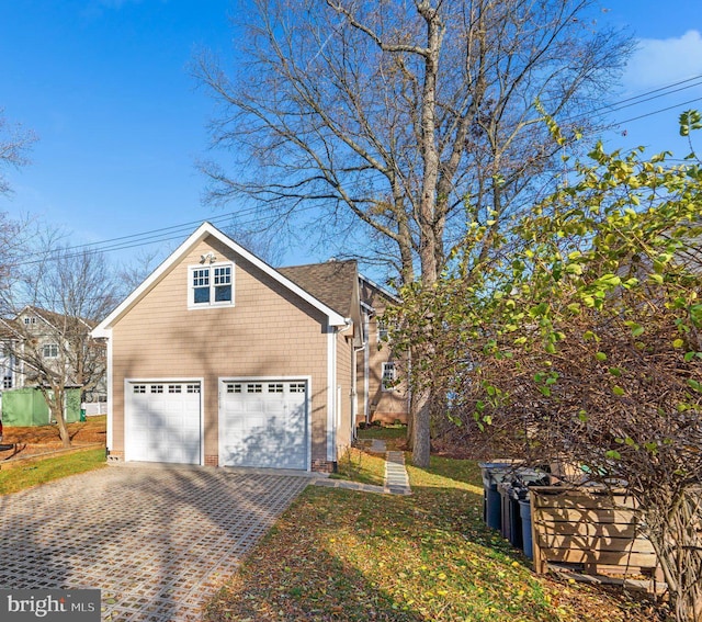 view of side of property with a garage