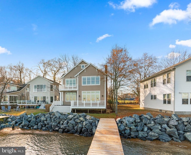 back of house featuring a deck with water view