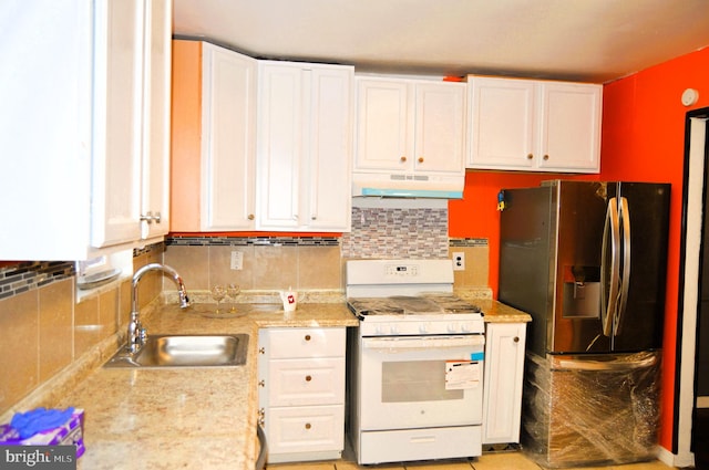 kitchen with white range with gas cooktop, white cabinets, sink, and stainless steel fridge with ice dispenser