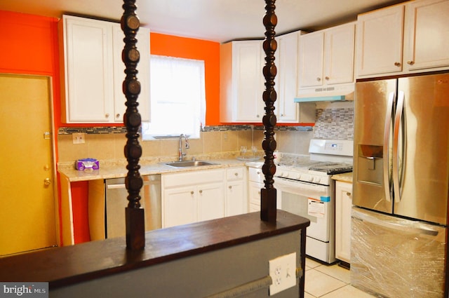 kitchen featuring white cabinets, light tile patterned floors, backsplash, sink, and stainless steel appliances