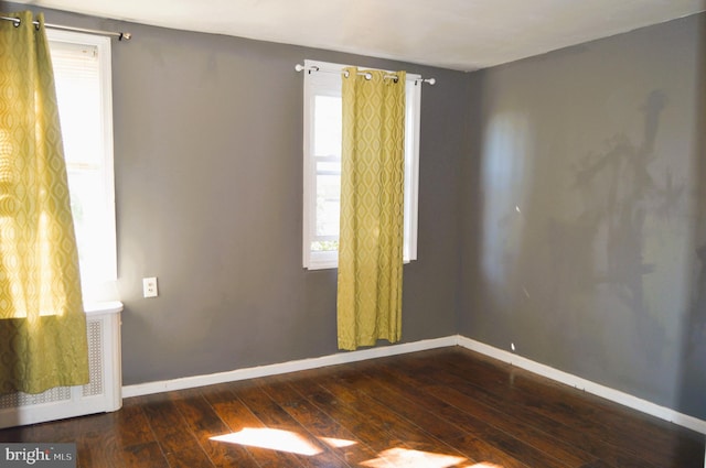 spare room featuring dark hardwood / wood-style floors