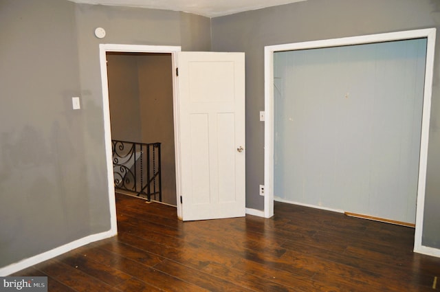 unfurnished bedroom featuring dark hardwood / wood-style floors