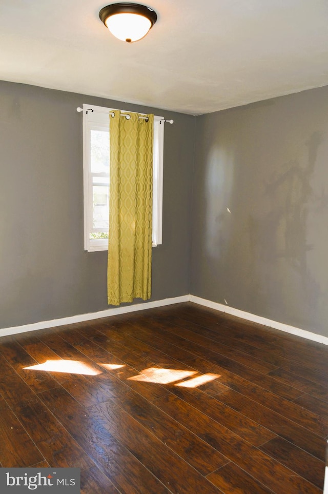 spare room featuring dark hardwood / wood-style floors