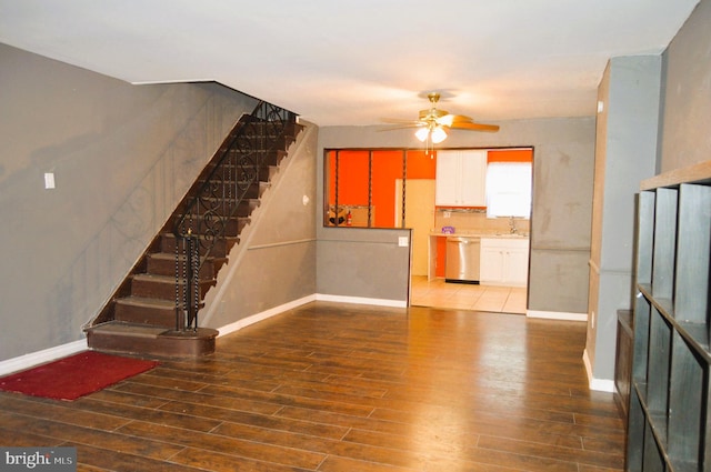 unfurnished living room featuring sink, hardwood / wood-style flooring, and ceiling fan