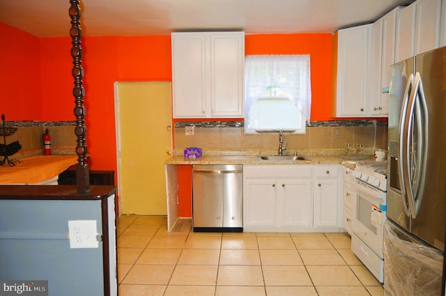 kitchen featuring sink, white cabinets, stainless steel appliances, and light tile patterned floors