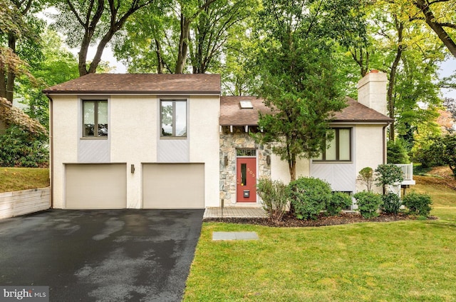 view of front of property with a front yard and a garage