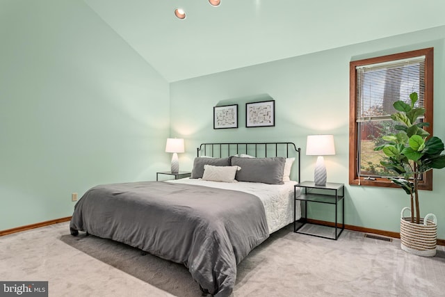 carpeted bedroom featuring vaulted ceiling