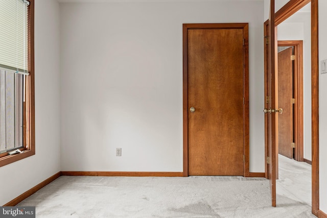 carpeted spare room featuring a healthy amount of sunlight