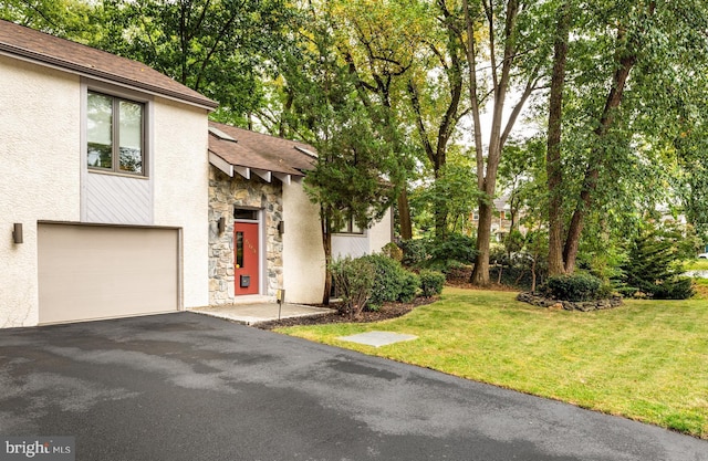 view of front of house with a garage and a front lawn