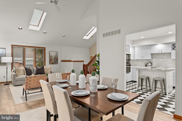 dining space with ceiling fan and light hardwood / wood-style floors