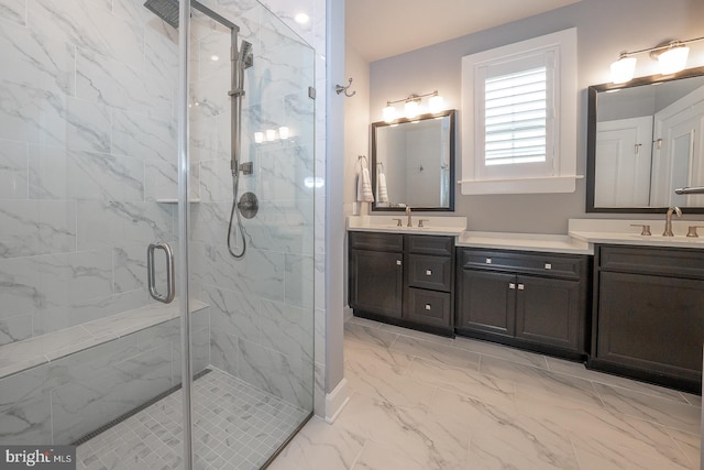 bathroom with a shower with door and vanity