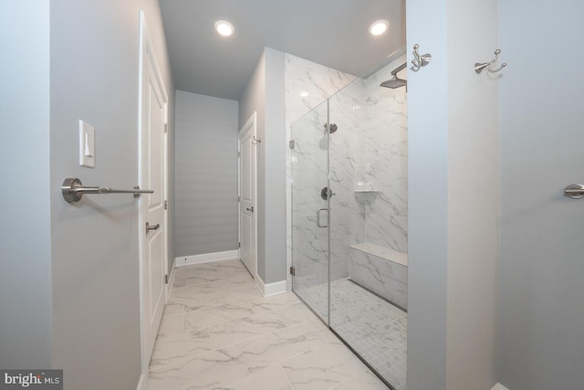 bathroom featuring a shower with door