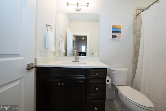 bathroom featuring tile patterned flooring, vanity, and toilet