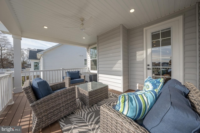 wooden terrace featuring outdoor lounge area and ceiling fan