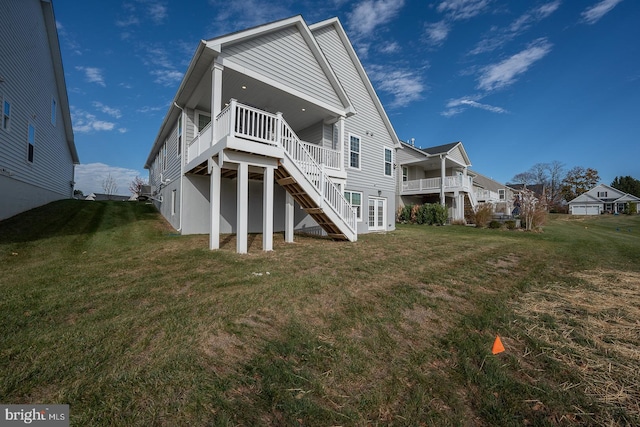 rear view of property featuring a wooden deck and a lawn