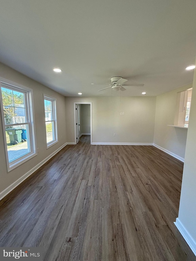 unfurnished room with dark hardwood / wood-style floors and ceiling fan