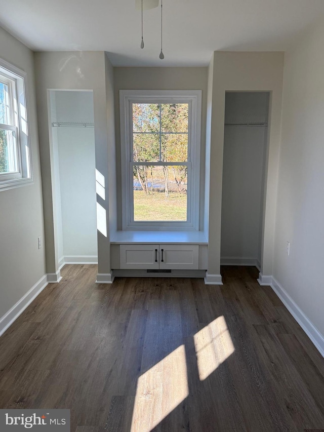 unfurnished bedroom with dark hardwood / wood-style flooring