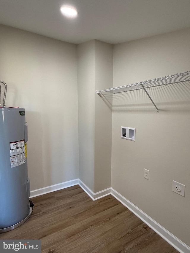 laundry area featuring dark wood-type flooring, washer hookup, electric dryer hookup, and electric water heater