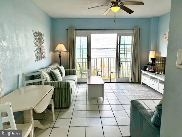 tiled living room with french doors and ceiling fan