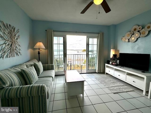 tiled living room featuring ceiling fan