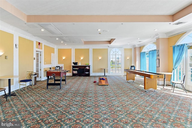 rec room featuring ornamental molding, carpet, and a raised ceiling