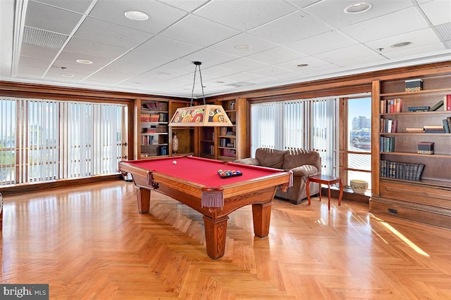 recreation room with a paneled ceiling, pool table, and light parquet flooring