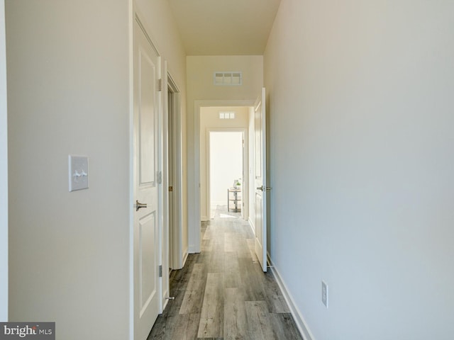 hallway with light hardwood / wood-style flooring