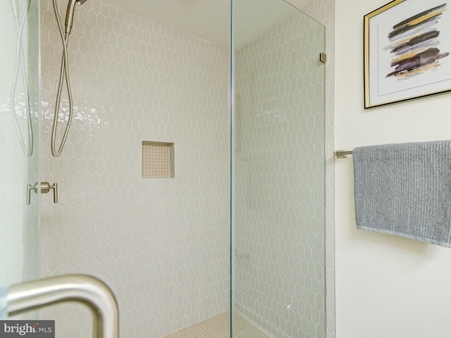 bathroom featuring a shower with door