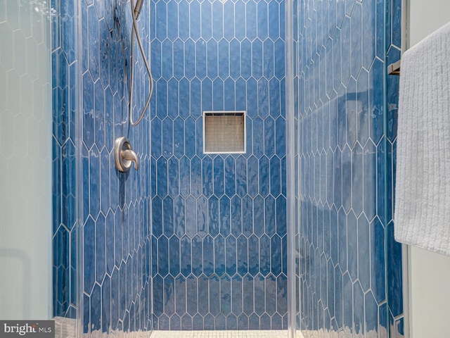 bathroom with a tile shower