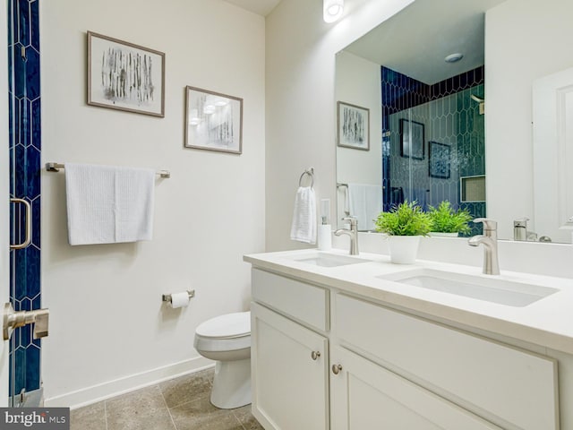 bathroom with a shower with door, vanity, and toilet