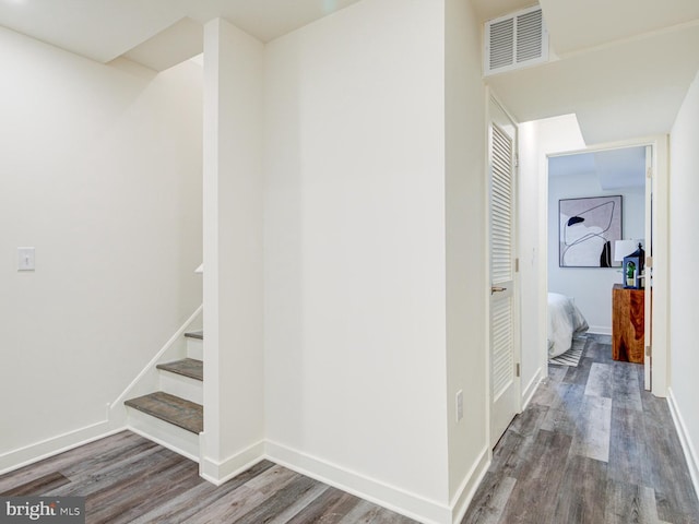 hallway with hardwood / wood-style flooring