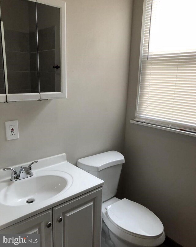 bathroom featuring vanity and toilet