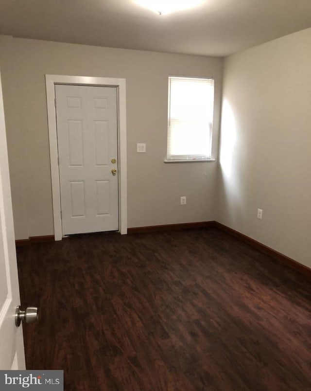 interior space with dark hardwood / wood-style floors