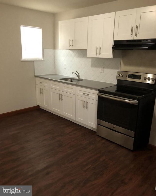 kitchen with sink, stainless steel range with electric cooktop, backsplash, white cabinets, and dark hardwood / wood-style floors