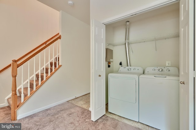 laundry room with light carpet and independent washer and dryer