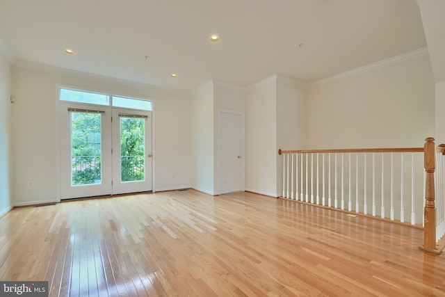 unfurnished room featuring crown molding and light wood-type flooring